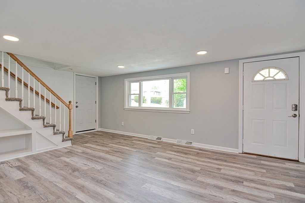 20 Alder Road Norton, MA 02766 - Photo 8 of 32 a view of an empty room with wooden floor and a window