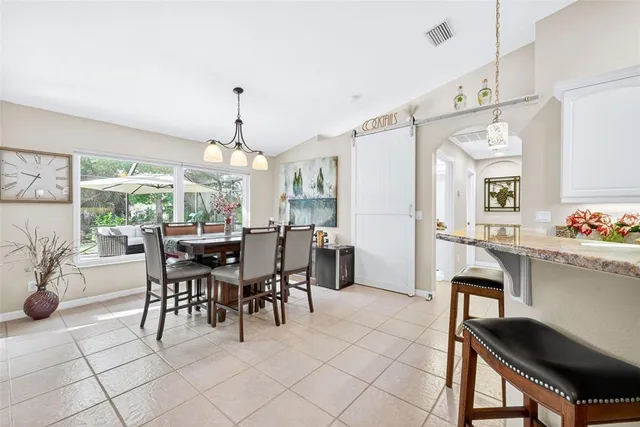 a view of a dining room with furniture and chandelier