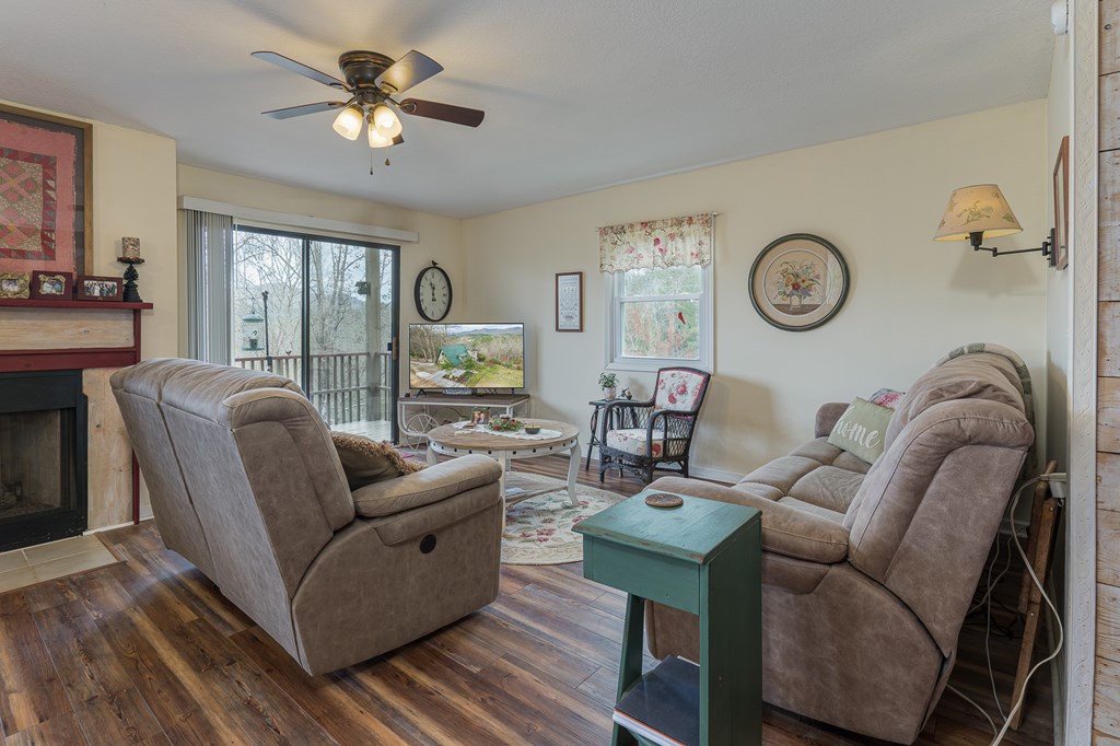 457 Persimmon Hts Road Murphy, NC 28906 - Photo 11 of 42 a living room with furniture a clock potted plant and a large window
