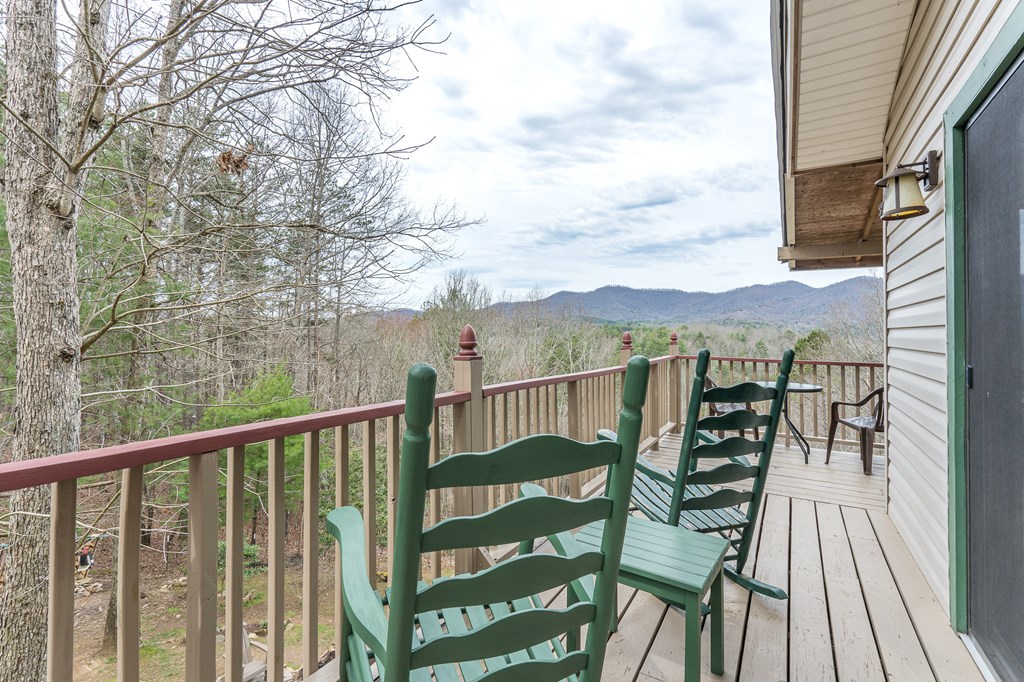457 Persimmon Hts Road Murphy, NC 28906 - Photo 26 of 42 a view of a balcony with chairs and wooden fence