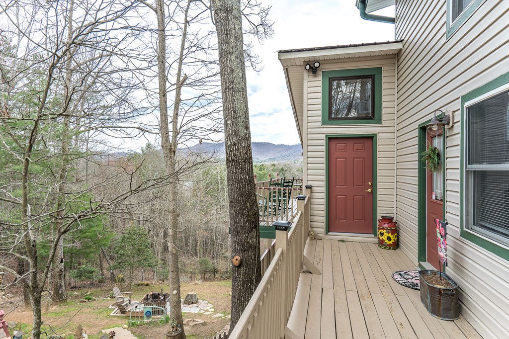 457 Persimmon Hts Road Murphy, NC 28906 - Photo 3 of 42 a view of a balcony with floor to ceiling windows and wooden floor