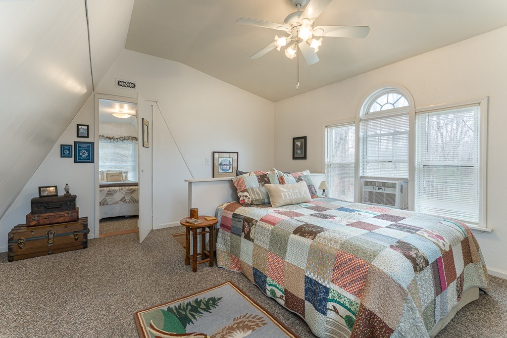 457 Persimmon Hts Road Murphy, NC 28906 - Photo 35 of 42 a bedroom with a bed and a chandelier