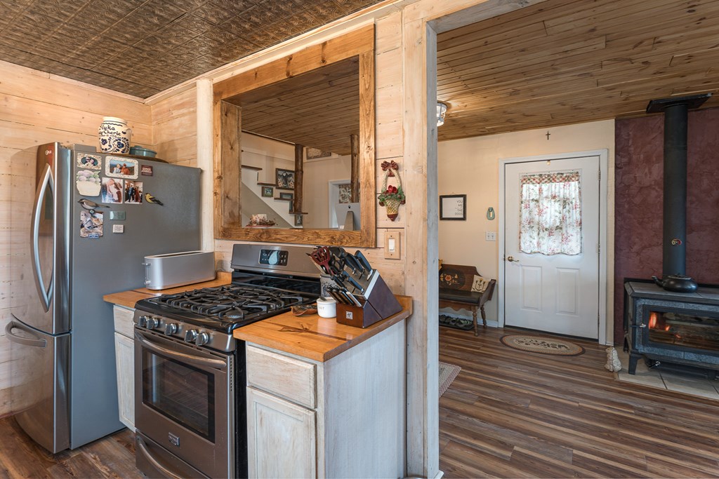 457 Persimmon Hts Road Murphy, NC 28906 - Photo 8 of 42 a kitchen with stainless steel appliances granite countertop a stove a refrigerator and a wooden cabinets