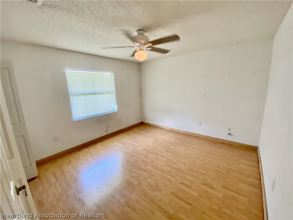 248 Tangerine Road Lake Placid, FL 33852 - Photo 10 of 16 wooden floor in an empty room with a window