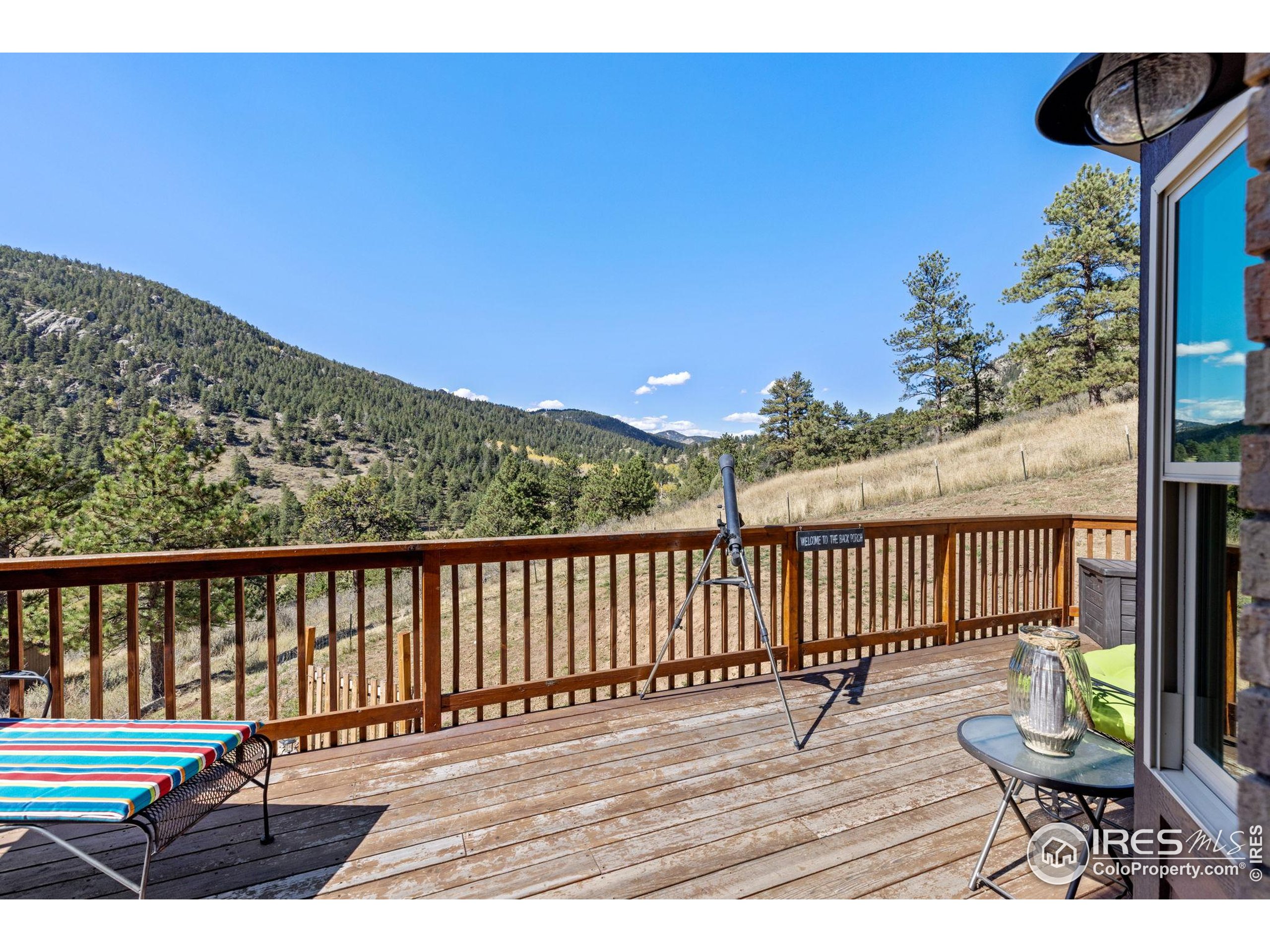 681 Bitterroot Gulch Road Loveland, CO 80537 - Photo 15 of 47 a view of balcony with wooden floor and bench