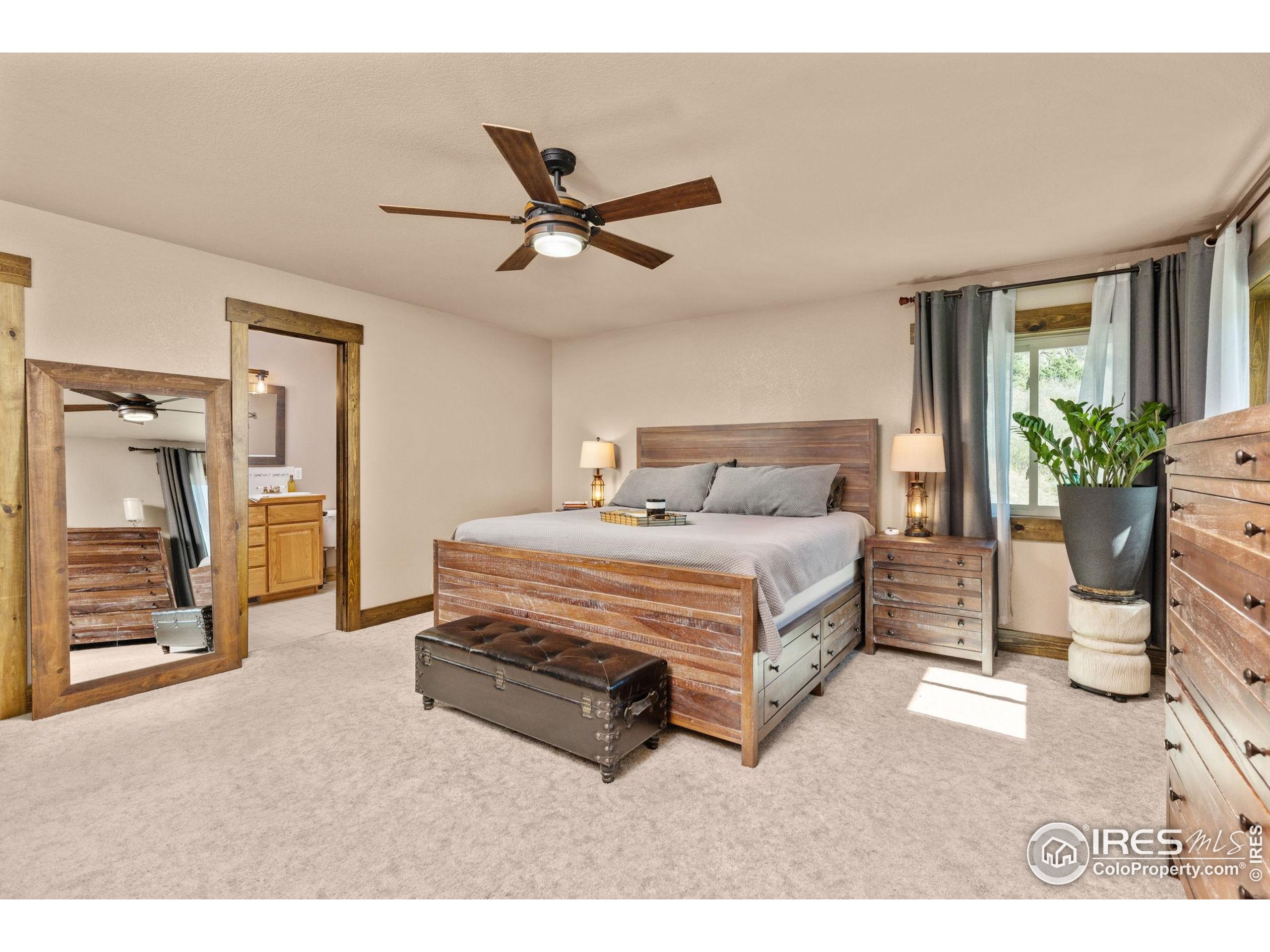 681 Bitterroot Gulch Road Loveland, CO 80537 - Photo 18 of 47 a bedroom with a bed and ceiling fan