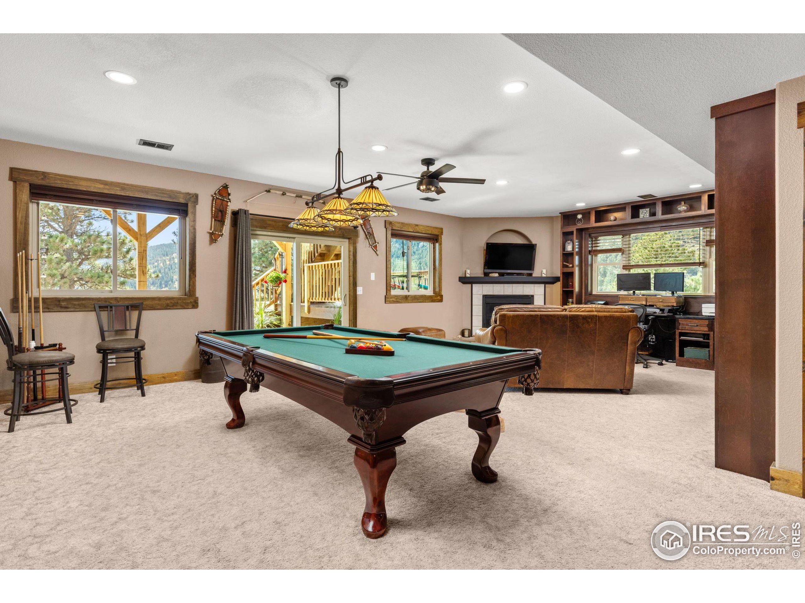 681 Bitterroot Gulch Road Loveland, CO 80537 - Photo 23 of 47 a living room with furniture pool table and flat screen tv