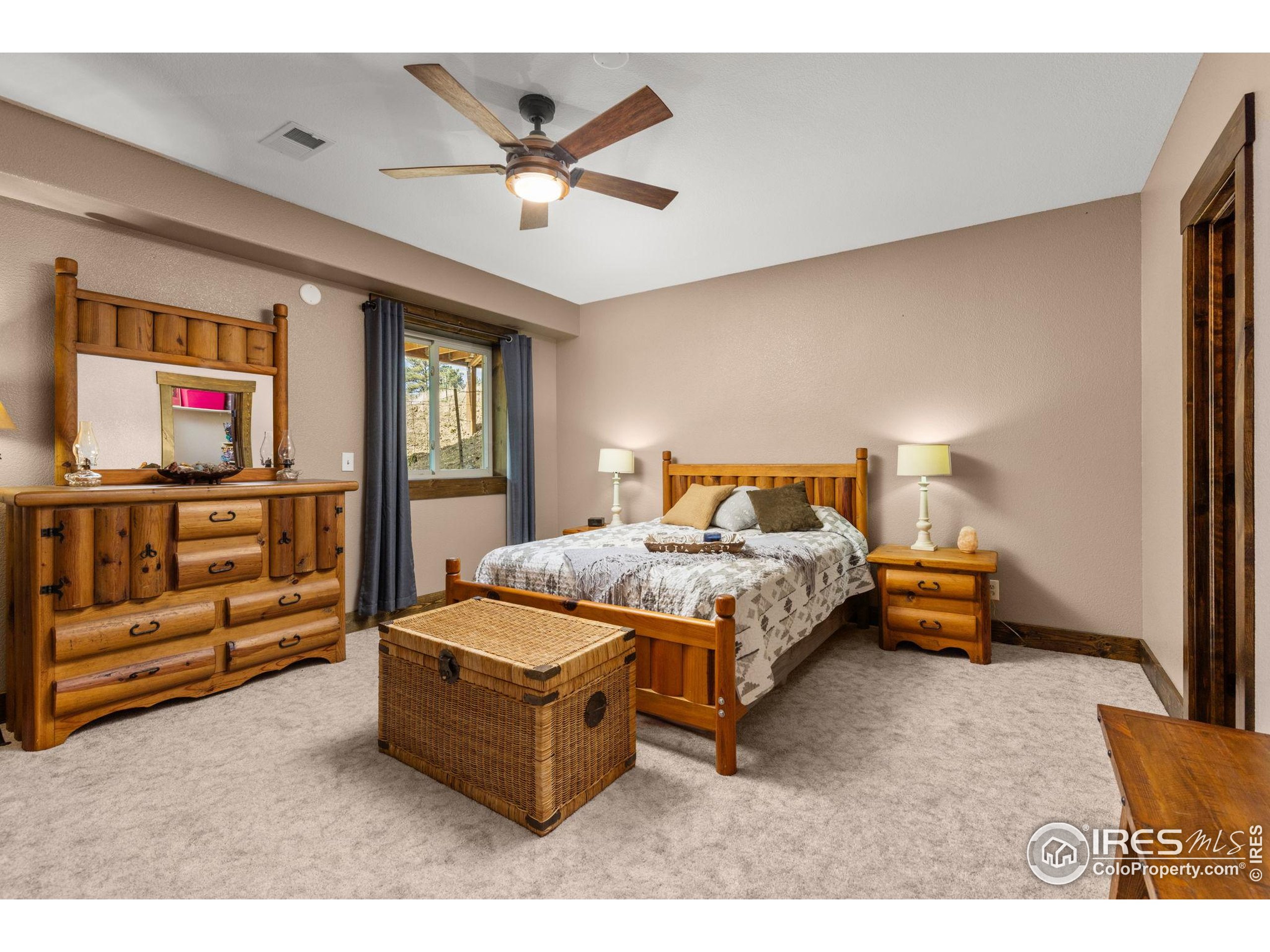 681 Bitterroot Gulch Road Loveland, CO 80537 - Photo 25 of 47 a bedroom with a bed and window