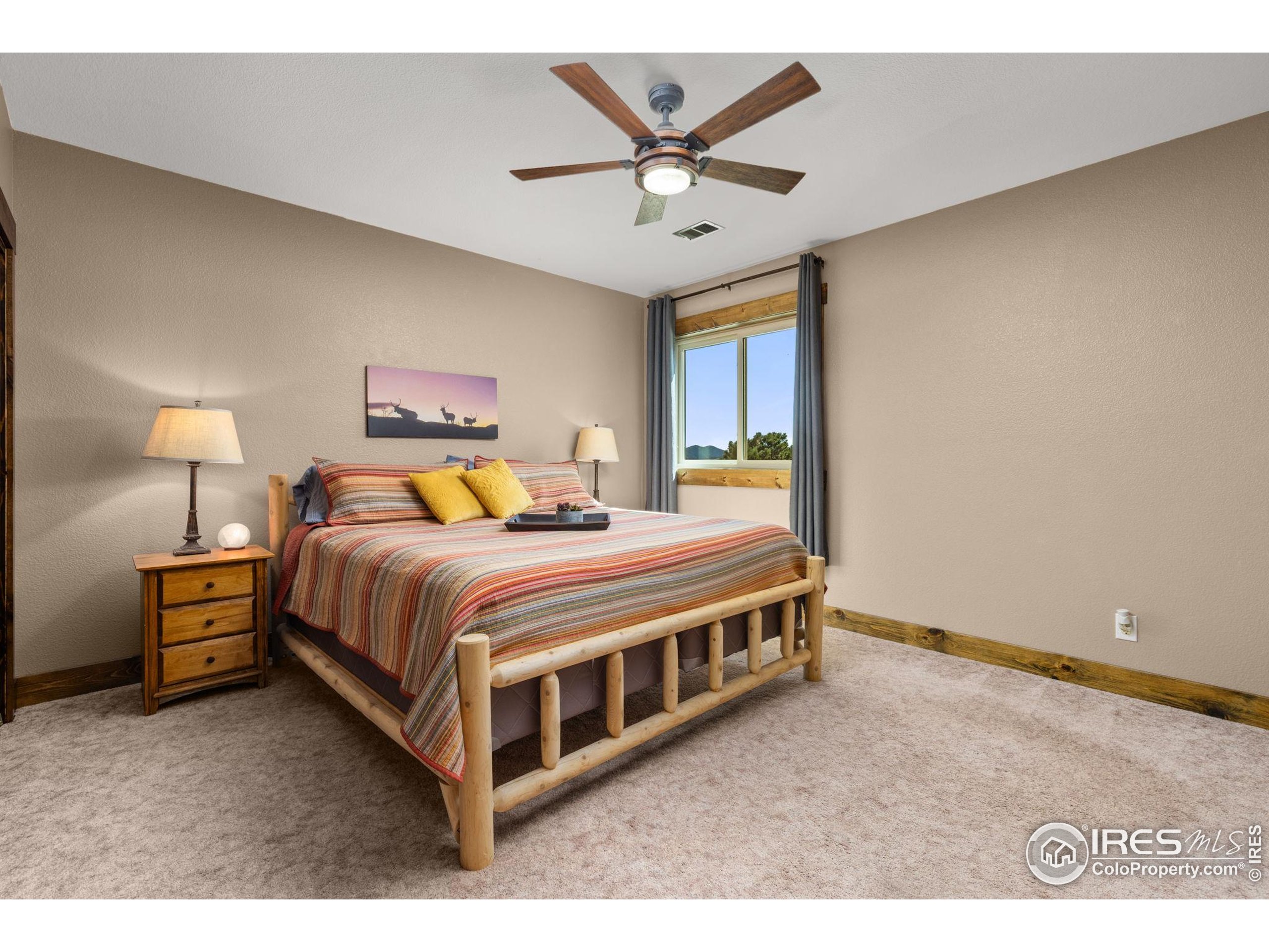 681 Bitterroot Gulch Road Loveland, CO 80537 - Photo 27 of 47 a bedroom with a bed and window