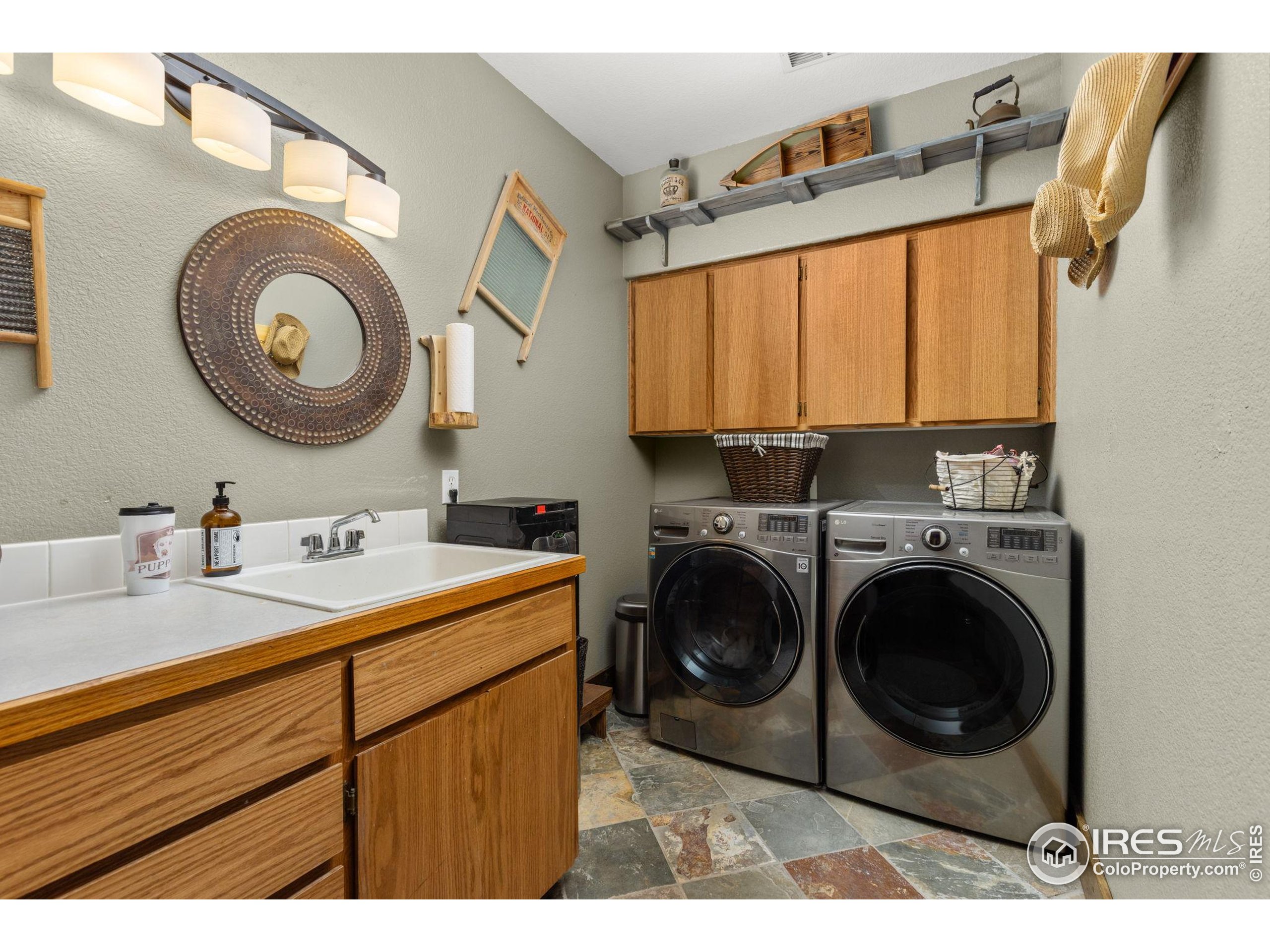 681 Bitterroot Gulch Road Loveland, CO 80537 - Photo 28 of 47 a utility room with sink dryer and washer