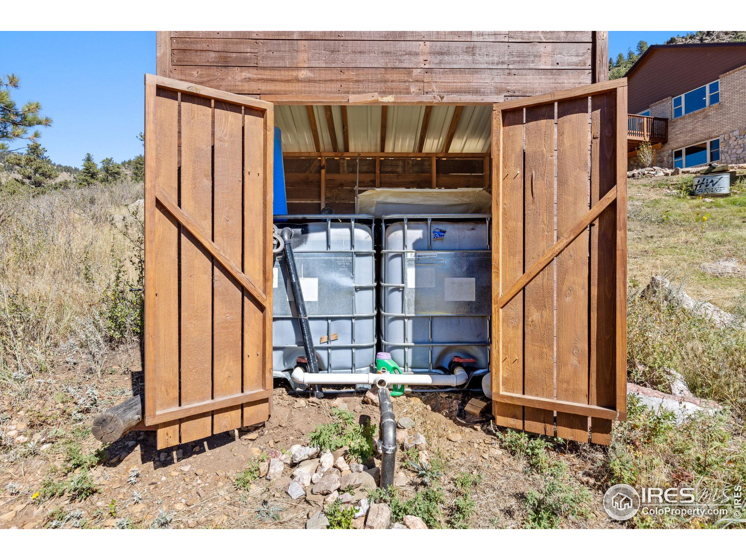 681 Bitterroot Gulch Road Loveland, CO 80537 - Photo 34 of 47 a backyard of a house with table and chairs
