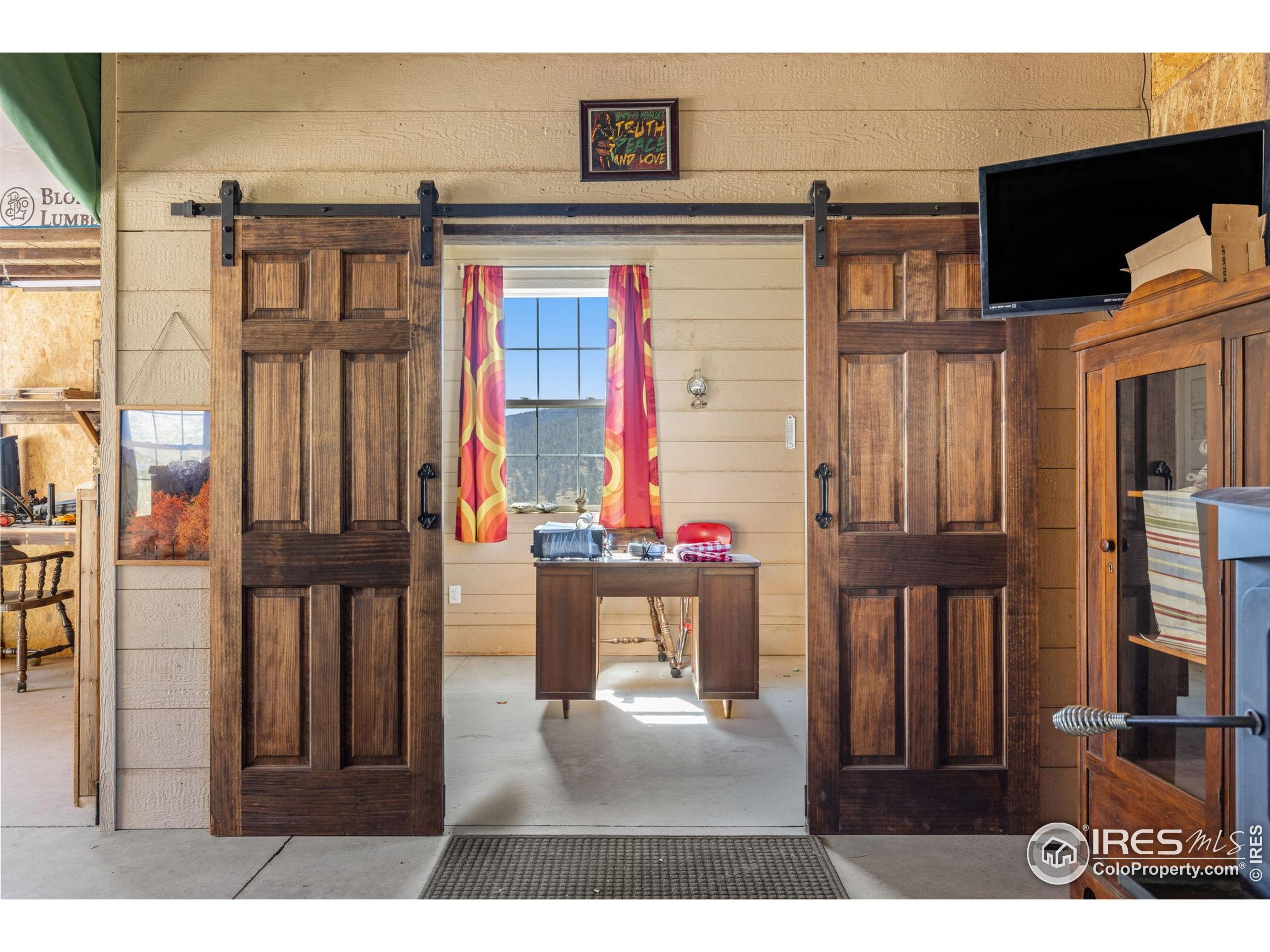 681 Bitterroot Gulch Road Loveland, CO 80537 - Photo 40 of 47 a kitchen with a refrigerator and a wooden floor