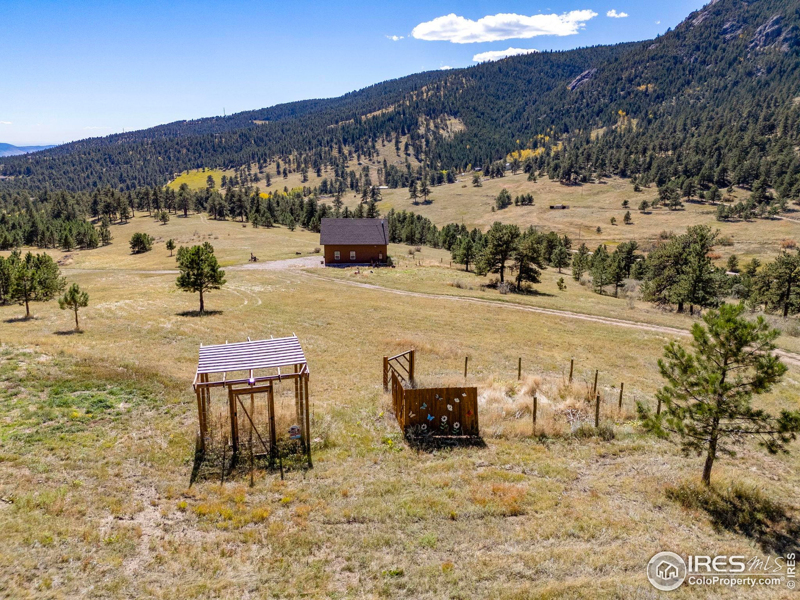 681 Bitterroot Gulch Road Loveland, CO 80537 - Photo 45 of 47 a view of a terrace with chairs and a mountain view