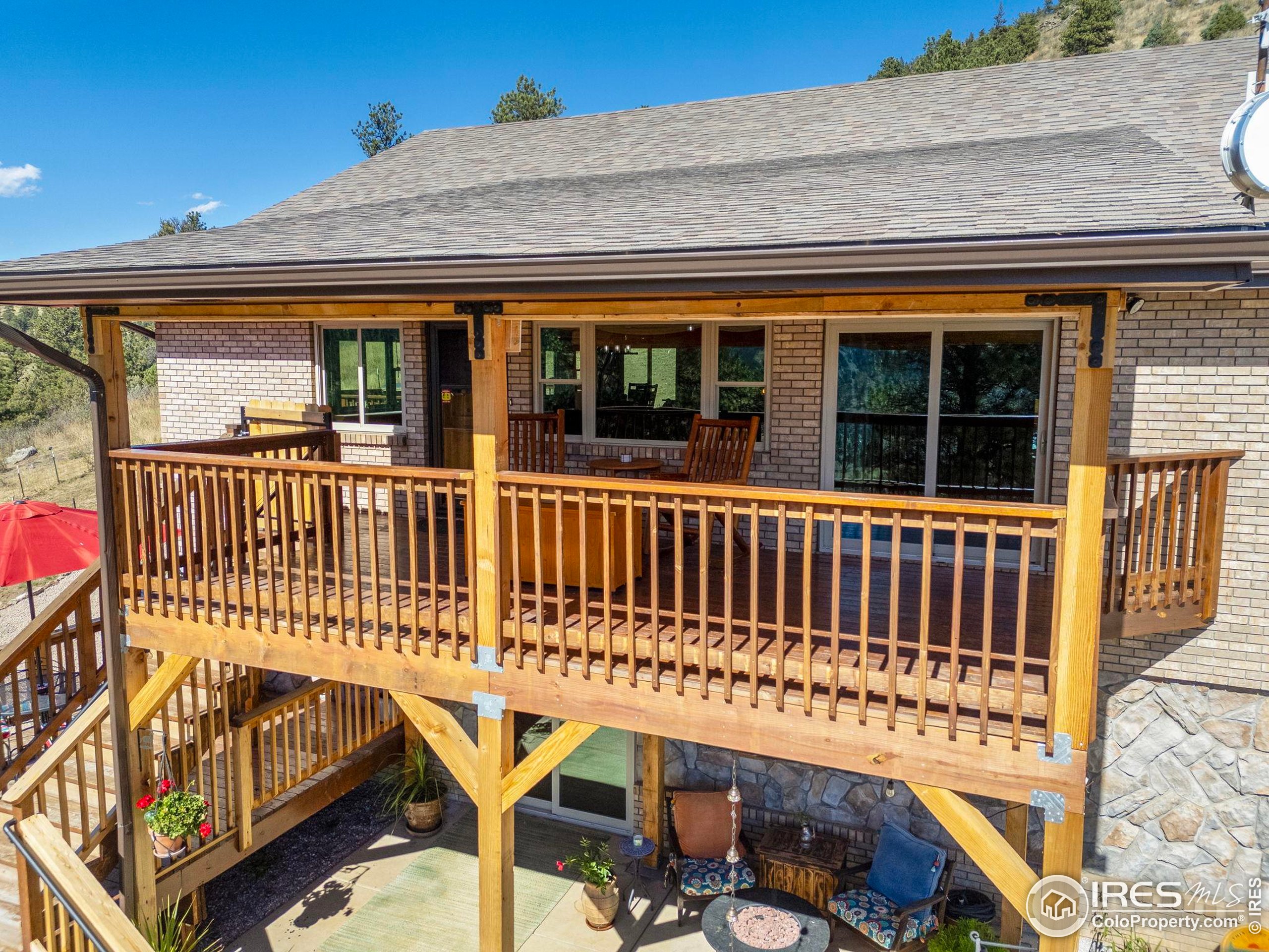 681 Bitterroot Gulch Road Loveland, CO 80537 - Photo 7 of 47 a view of a roof deck with chair and wooden floor