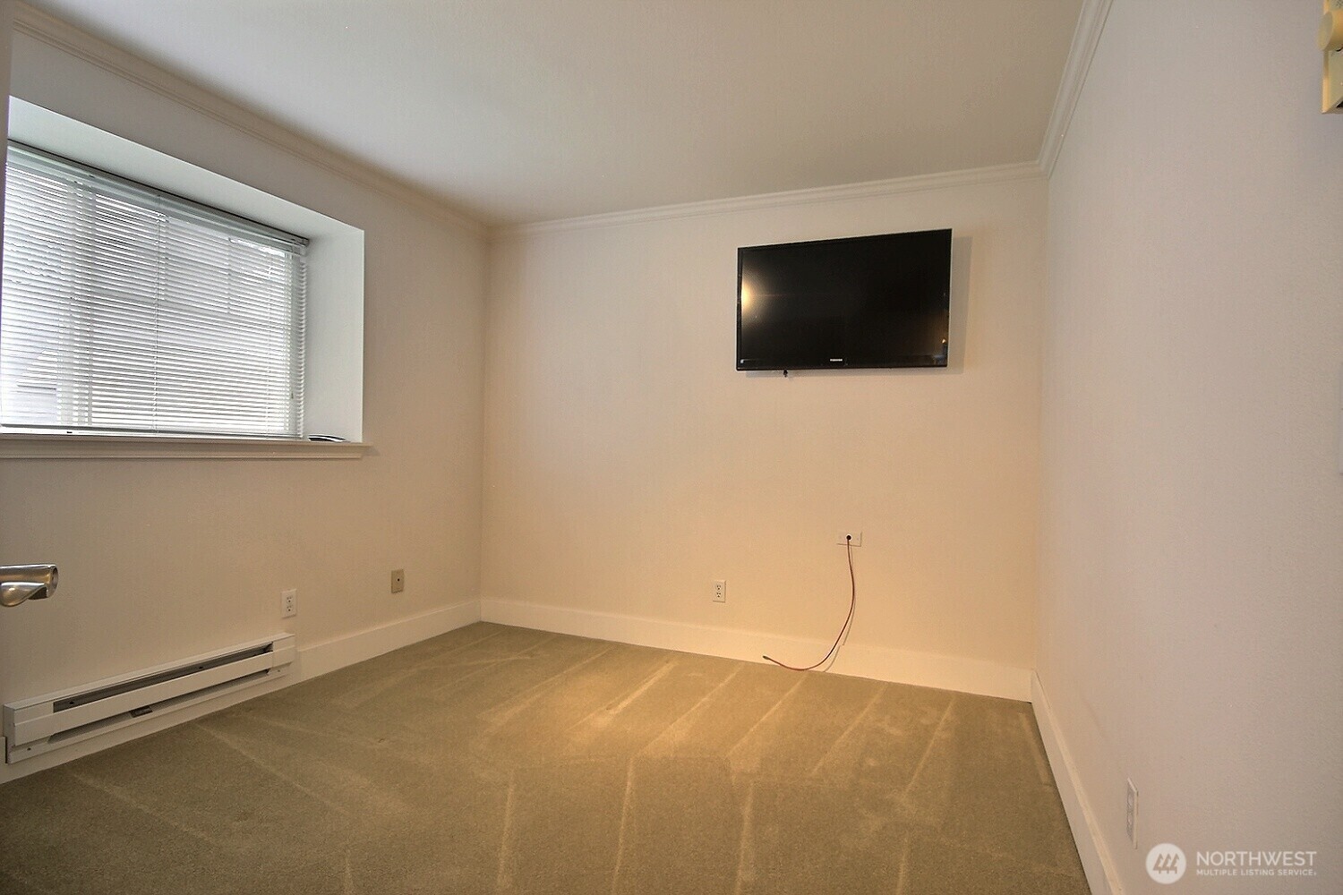 5409 South 237th Place, Unit 164 Kent, WA 98032 - Photo 17 of 25 a view of an empty room with a window and a flat screen tv