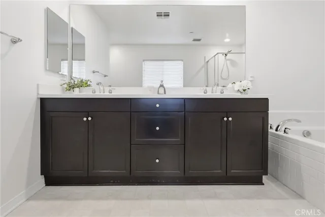 a bathroom with a sink vanity and mirror