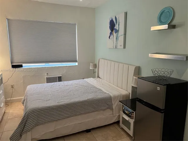 a bedroom with a bed and chair