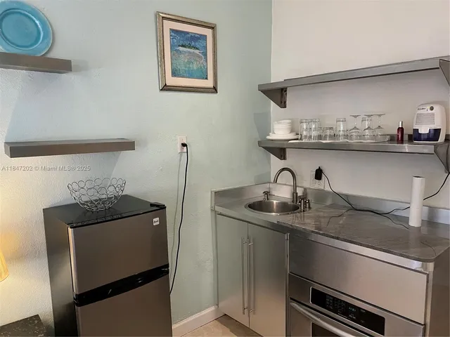 a kitchen with stainless steel appliances granite countertop a sink and a stove
