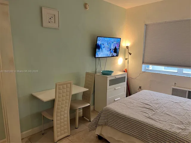a bedroom with a bed and a desk
