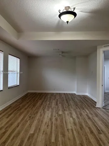 a view of a room with wooden floor