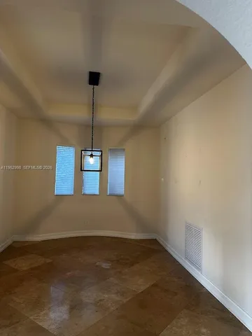 a kitchen with stainless steel appliances granite countertop a refrigerator a stove a sink and a microwave