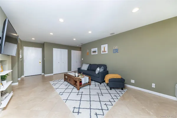 a living room with furniture and large windows