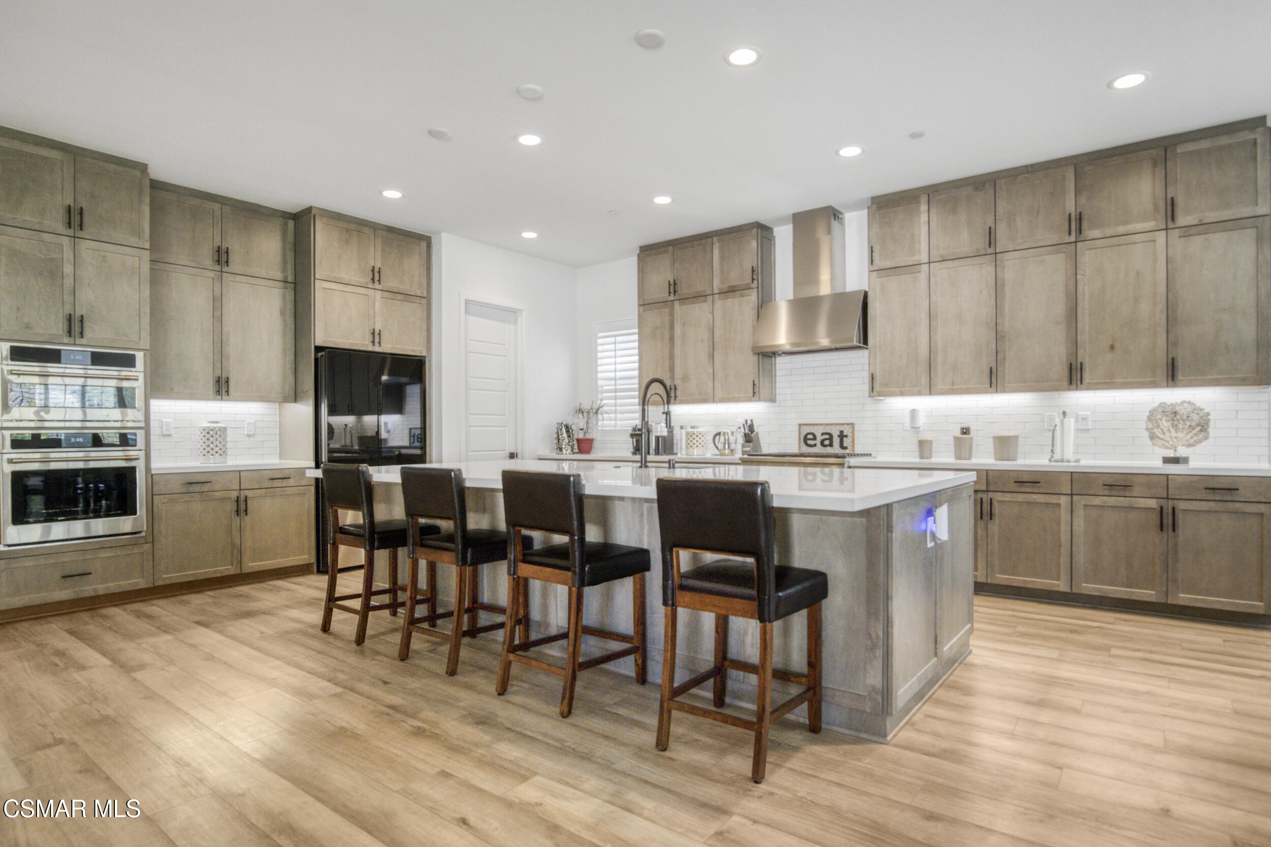 28665 Windbreak Trail Saugus, CA 91350 - Photo 12 of 56 a kitchen with kitchen island granite countertop a sink cabinets and stainless steel appliances