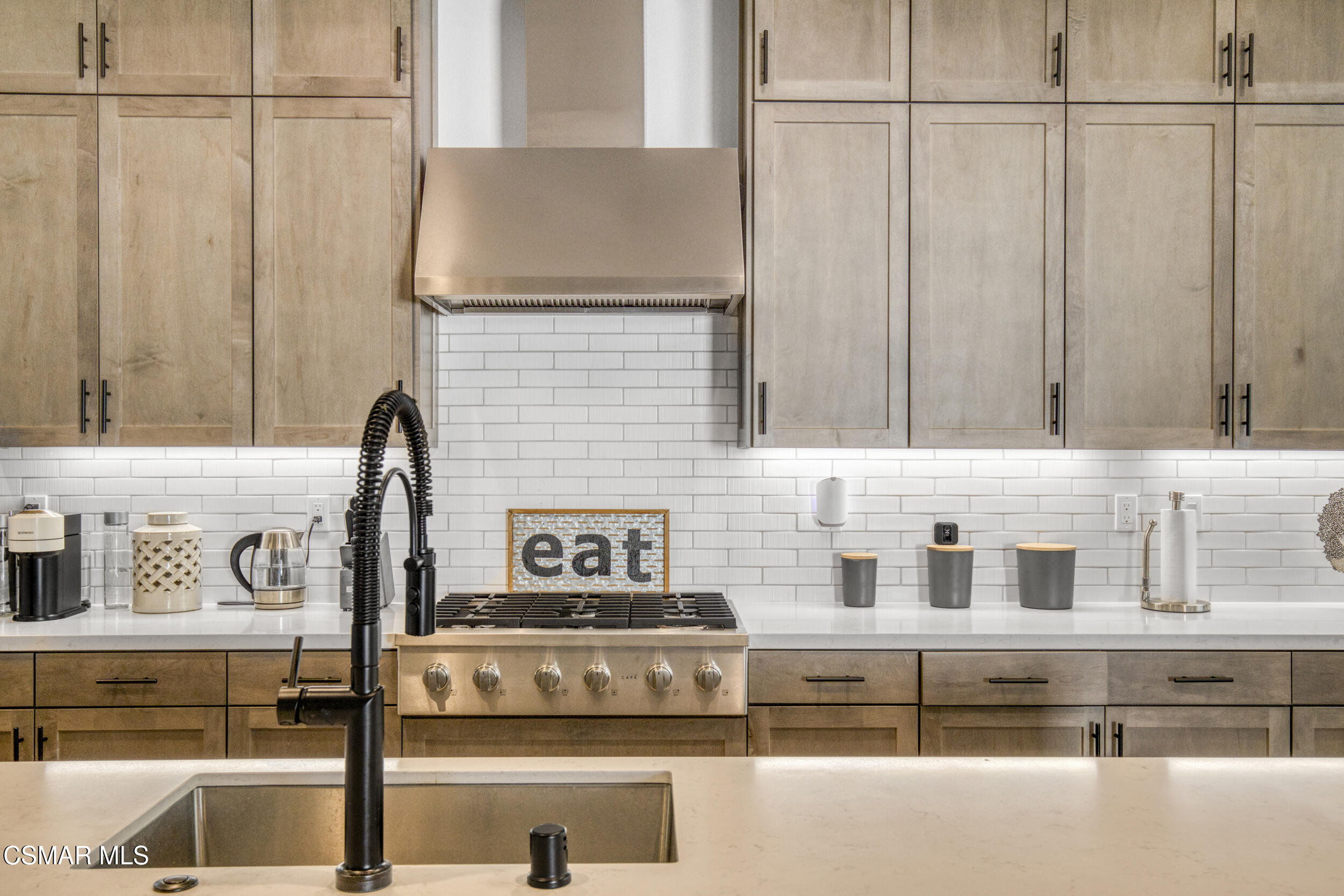 28665 Windbreak Trail Saugus, CA 91350 - Photo 13 of 56 a kitchen with stainless steel appliances granite countertop white cabinets and a stove