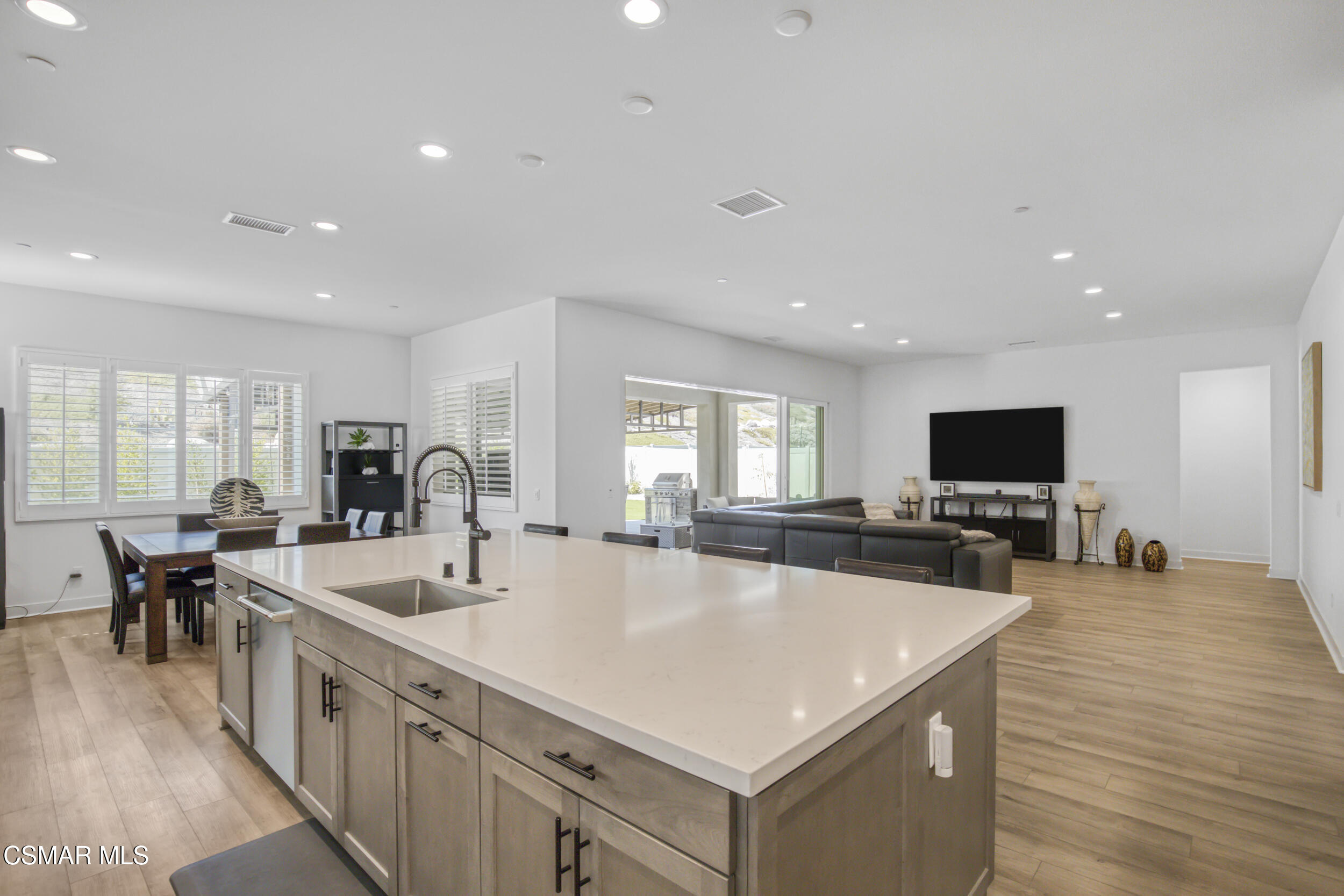 28665 Windbreak Trail Saugus, CA 91350 - Photo 14 of 56 a large white kitchen with a large island in the center
