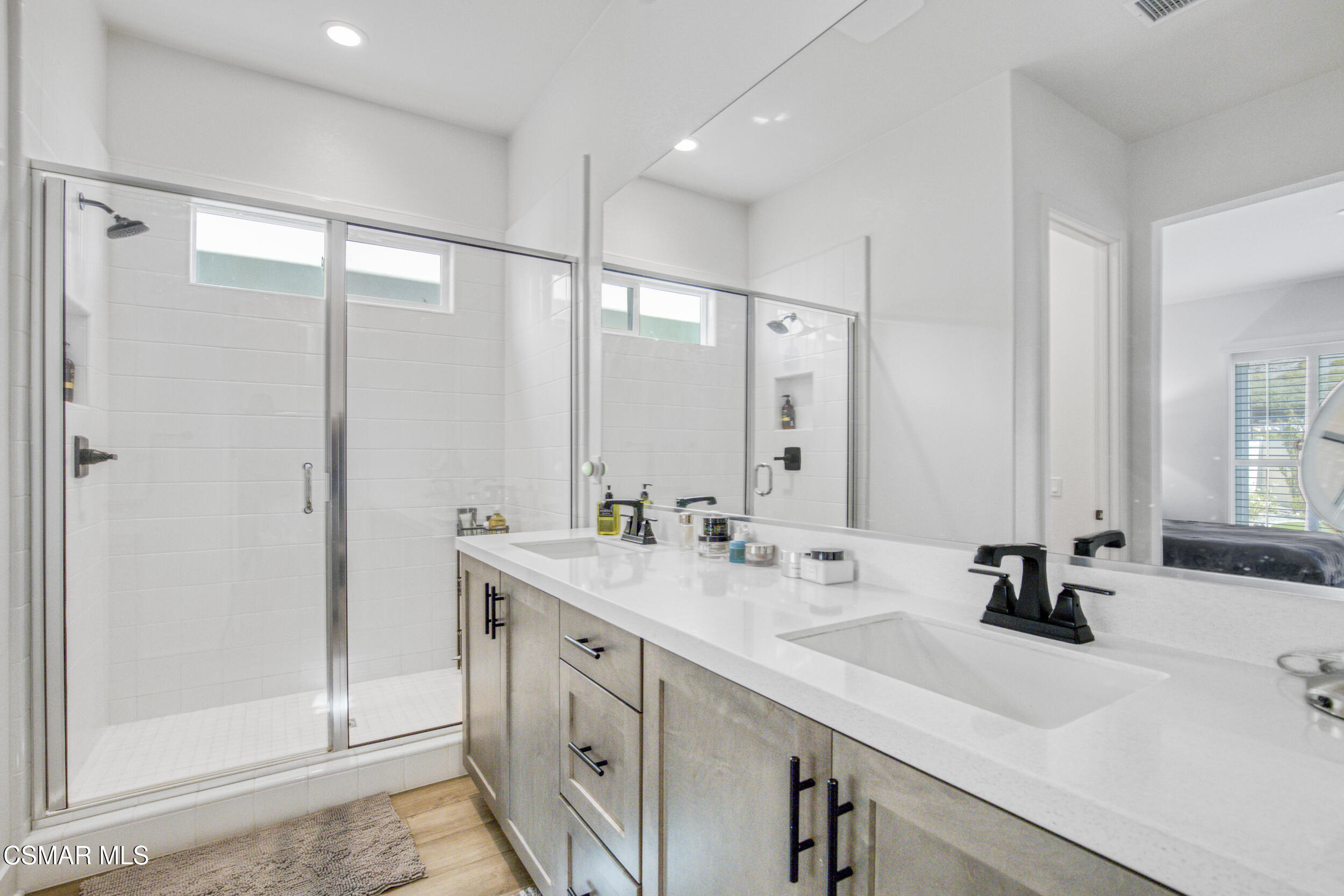 28665 Windbreak Trail Saugus, CA 91350 - Photo 18 of 56 a bathroom with double vanity sinks and a mirror