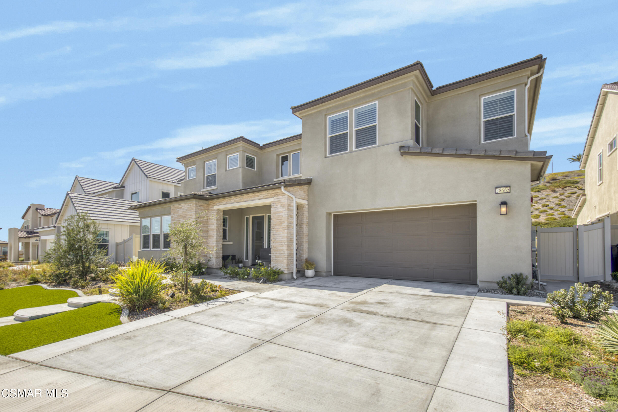 28665 Windbreak Trail Saugus, CA 91350 - Photo 2 of 56 a front view of a house with a garden