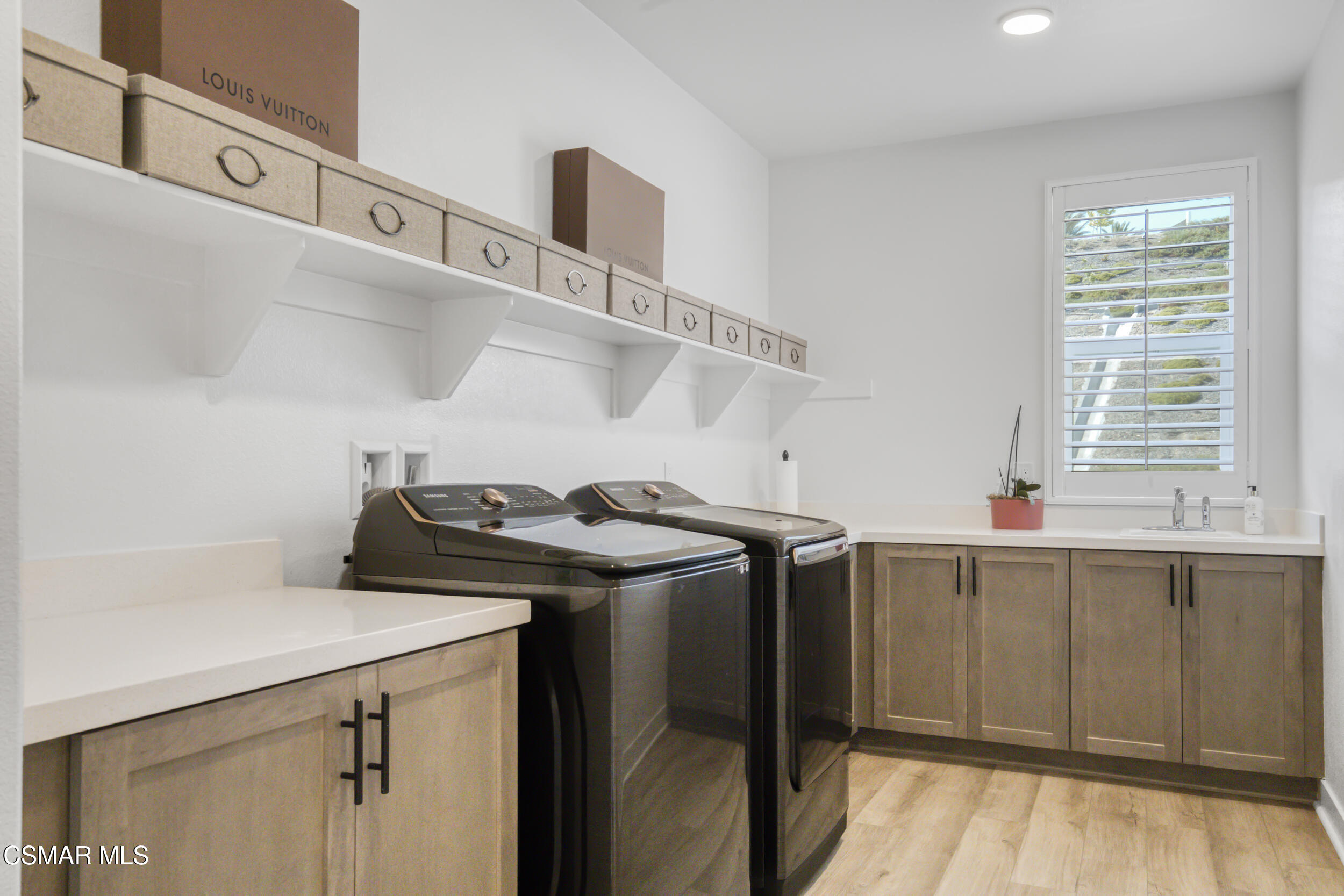 28665 Windbreak Trail Saugus, CA 91350 - Photo 25 of 56 a utility room with cabinets washer and dryer