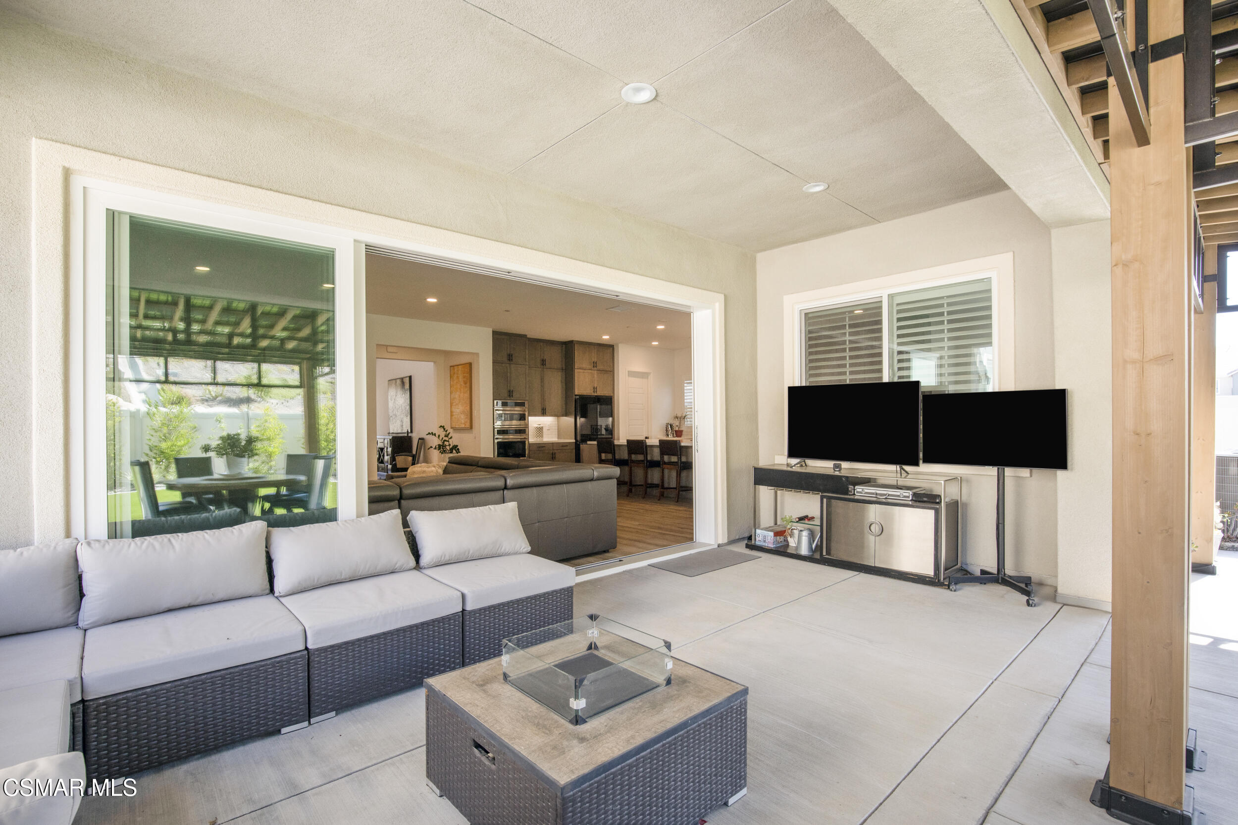 28665 Windbreak Trail Saugus, CA 91350 - Photo 31 of 56 a living room with furniture a flat screen tv and a floor to ceiling window