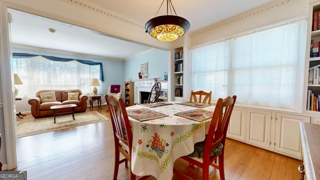 a view of a dining room with furniture and a chandelier