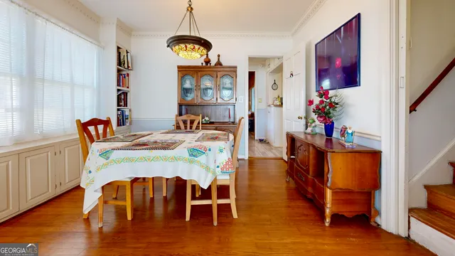 a view of a dining room with furniture window and wooden floor