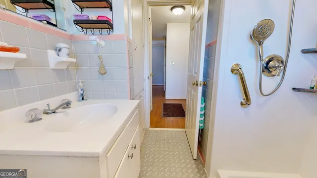 a bathroom with a sink a toilet and a mirror