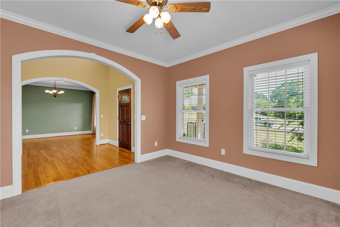 406 Hopewell Ridge Anderson, SC 29621 - Photo 7 of 46 This inviting room offers comfortable carpeting, crown molding, and a seamless transition to hardwood flooring.