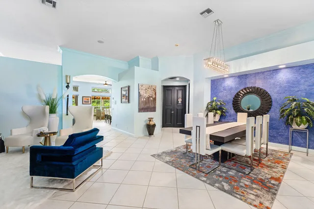 a kitchen with granite countertop white cabinets and stainless steel appliances