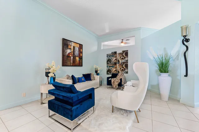 a living room with furniture a table and large window
