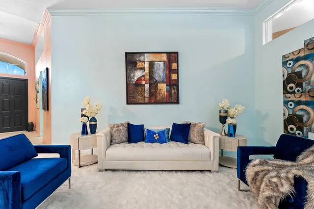 a kitchen with stainless steel appliances granite countertop table chairs and a refrigerator
