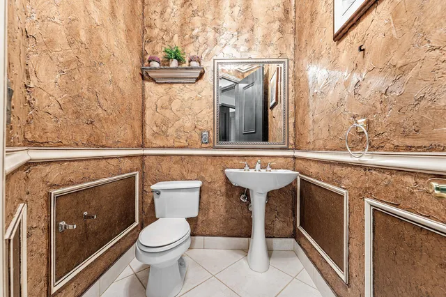 a bedroom with a bed and a table with wooden floor