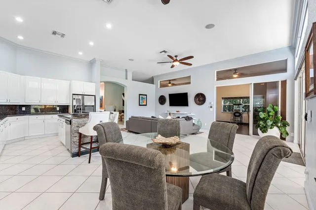 a utility room with stainless steel appliances wooden floor and furniture