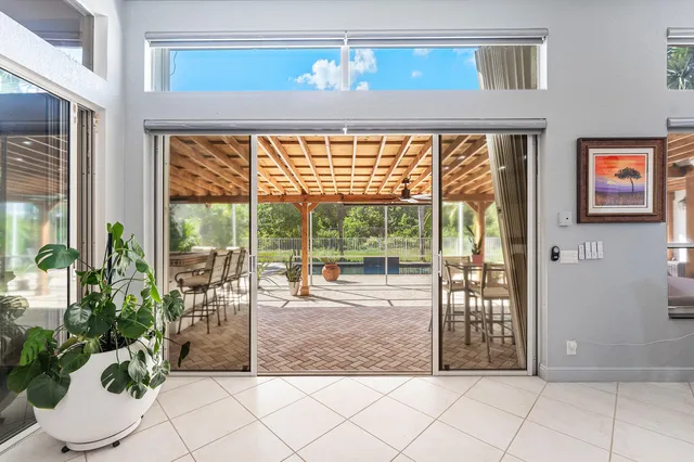 a dining hall with stainless steel appliances kitchen island granite countertop a sink and cabinets
