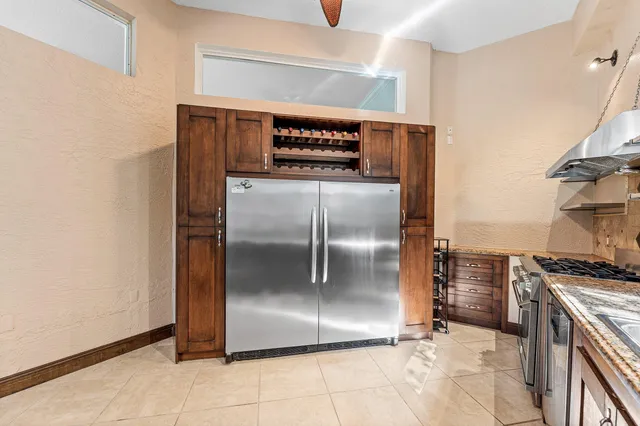 a living room with couches a table and a bookshelf with wooden floor