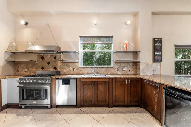 a kitchen with stainless steel appliances a refrigerator sink and cabinets