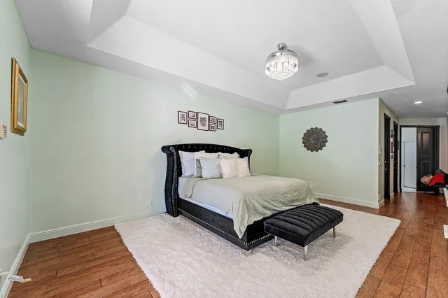 a room with lots of tables a mirror and clock on the wall