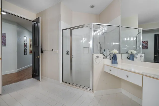 a vase of flowers sitting on a wooden floor