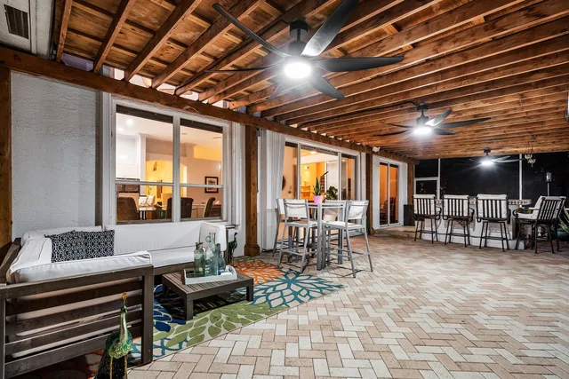 a view of a house with swimming pool and sitting area