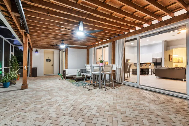 a view of swimming pool with outdoor seating and a potted plants