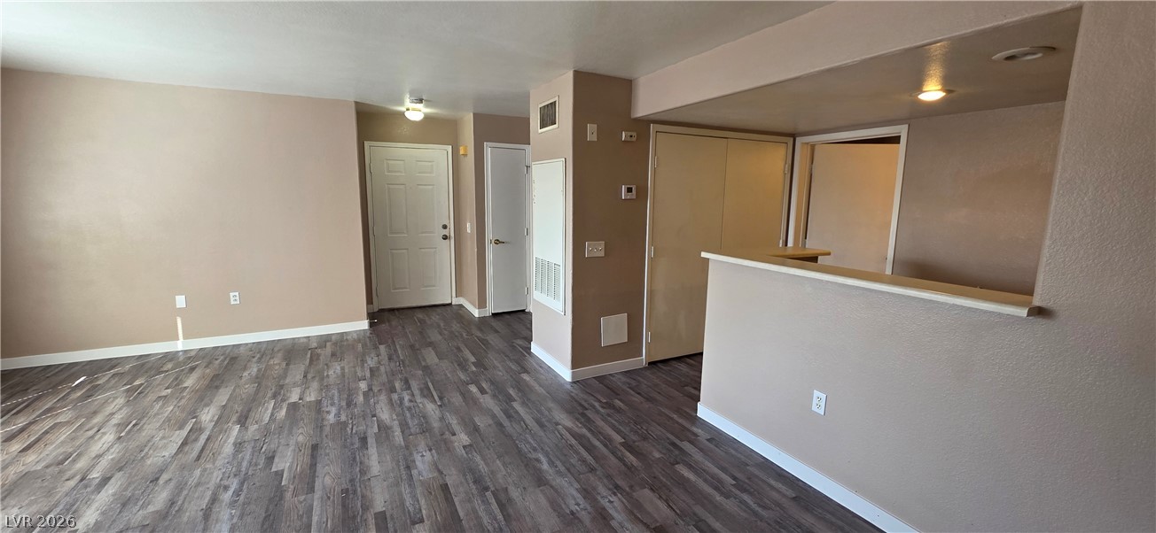 1830 North Pecos Road, Unit 142 Las Vegas, NV 89115 - Photo 6 of 19 Natural light illuminates the versatile living area, showcasing rich flooring and clean architectural lines.